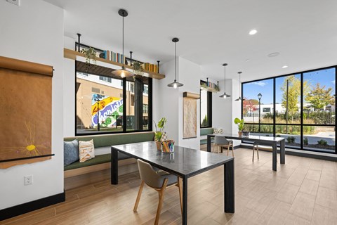 A modern dining room with a table and chairs.