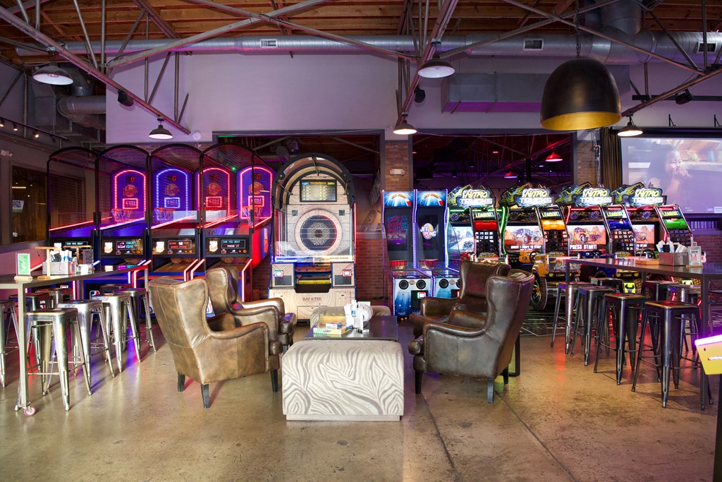 a casino with chairs and tables and slot machines