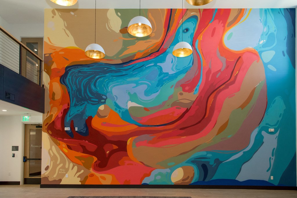 a colorful wall mural in a lobby of a building