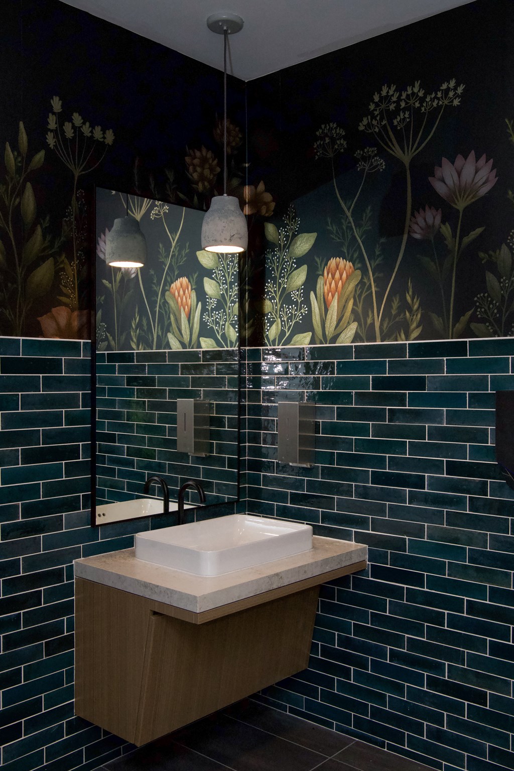 a bathroom with blue tiled walls and a white sink