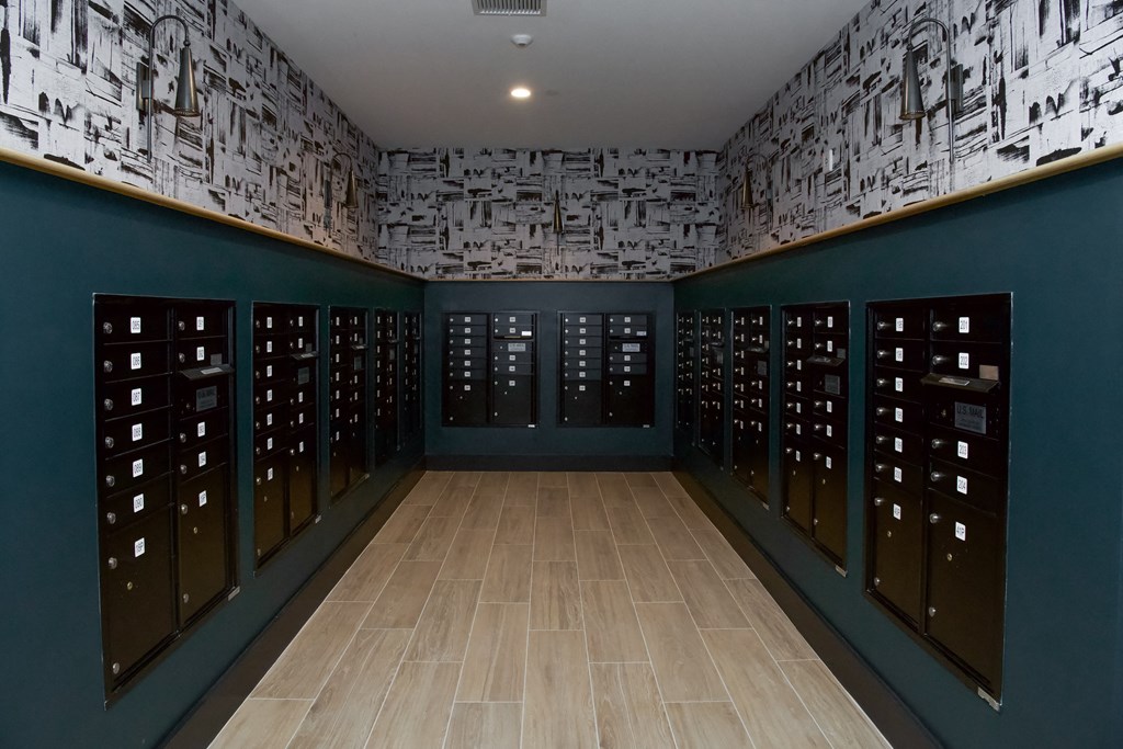 a room with rows of wine racks and a wood floor