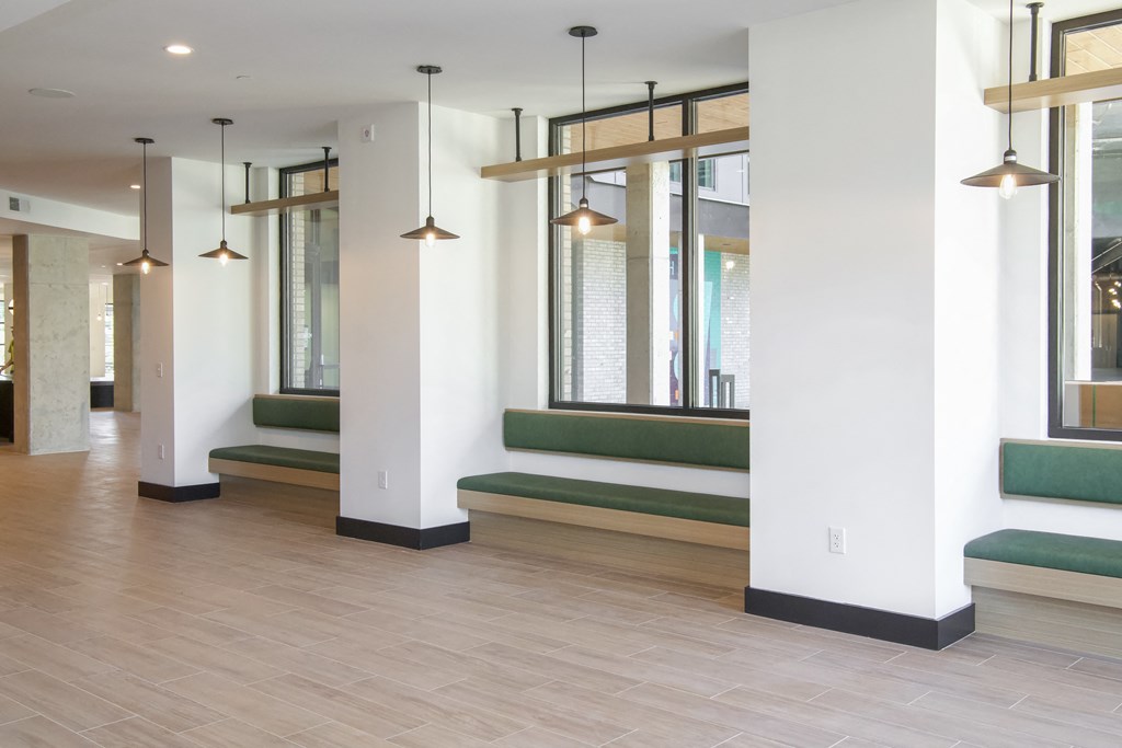 a corridor with benches and windows in a building