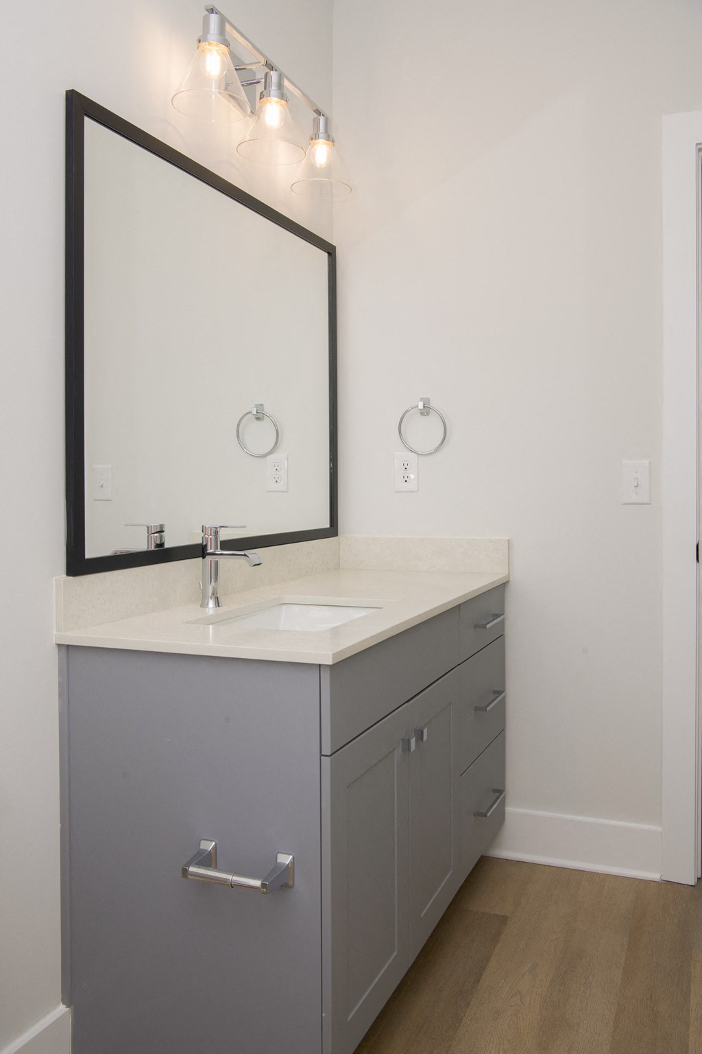 a white bathroom with a sink and a mirror