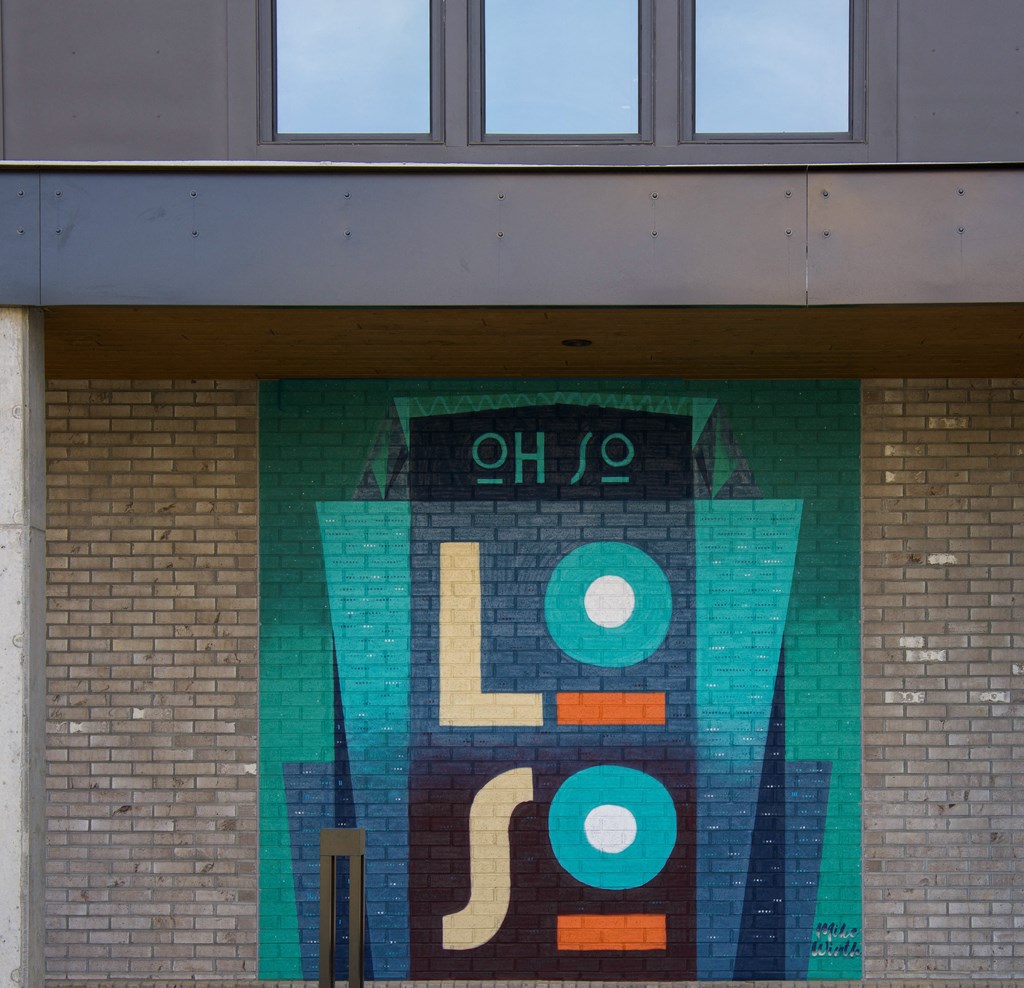 a mural of a robot on the side of a building