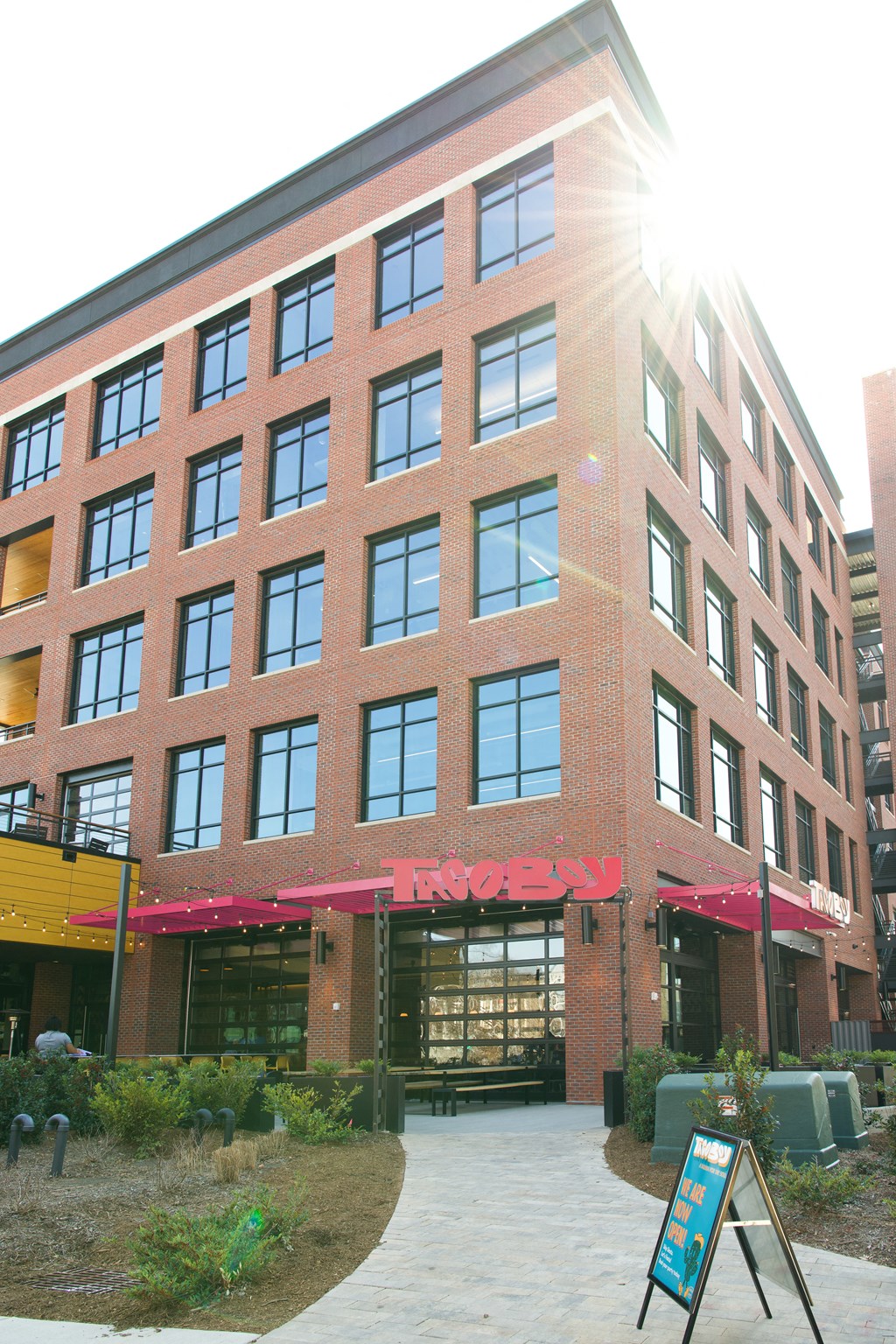 a large brick building with a sidewalk in front of it