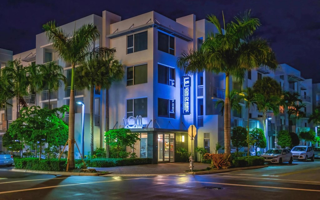 Evening View of South of Atlantic Luxury Apartments with Vibrant Blue Accent Lighting