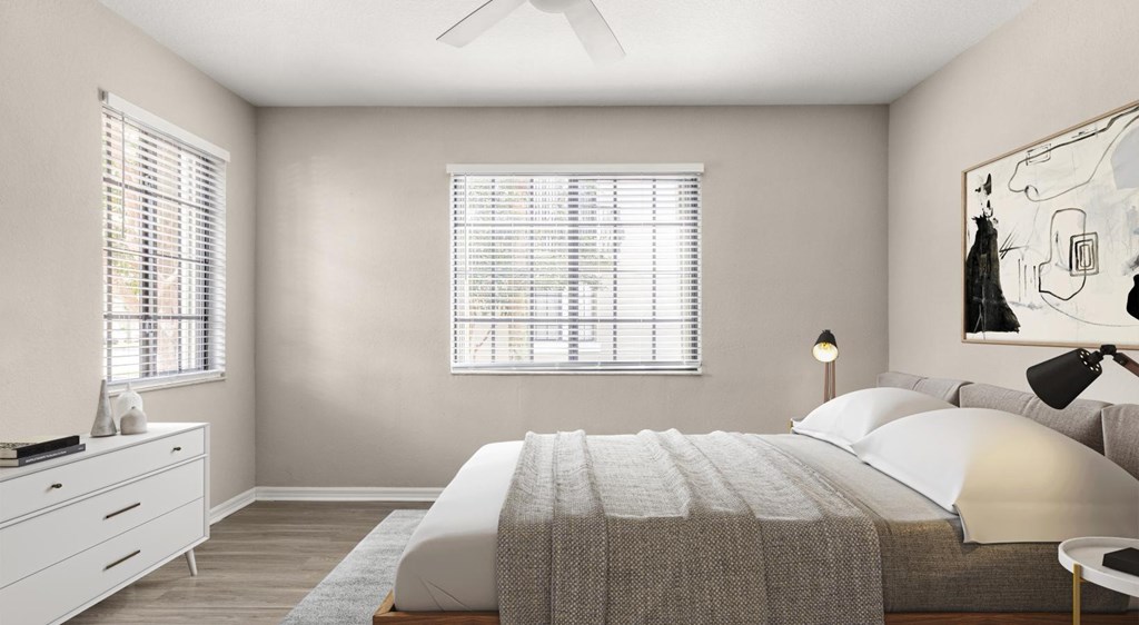 A bedroom with a bed, dresser, and window.