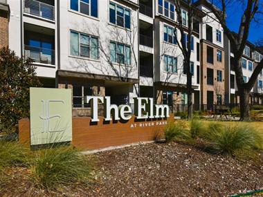 the elm at river park apartments sign
