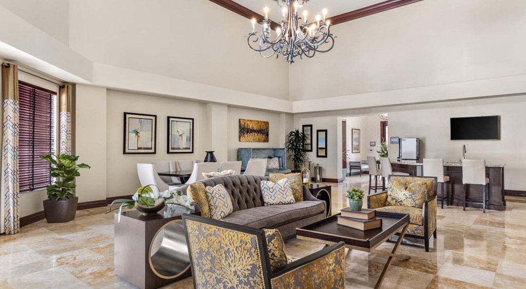 A living room with a chandelier, couches, and a coffee table.