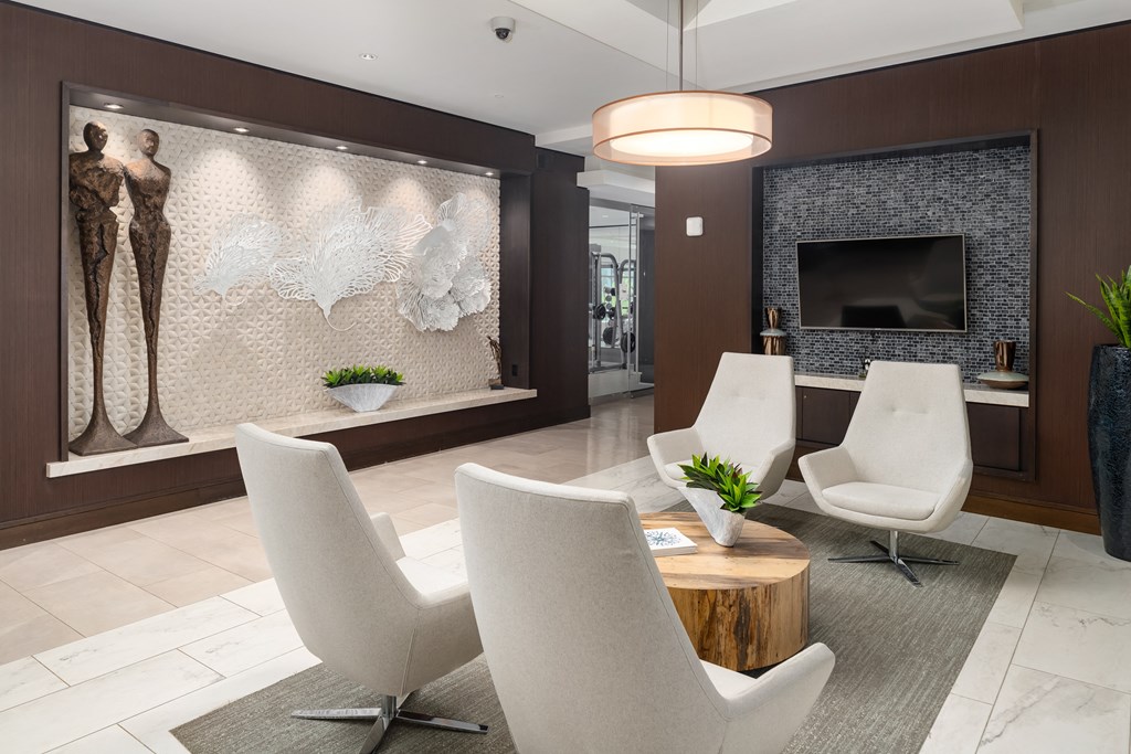 Apartment Lobby with Contemporary Seating, Sculptural Wall Art, and Mounted TV