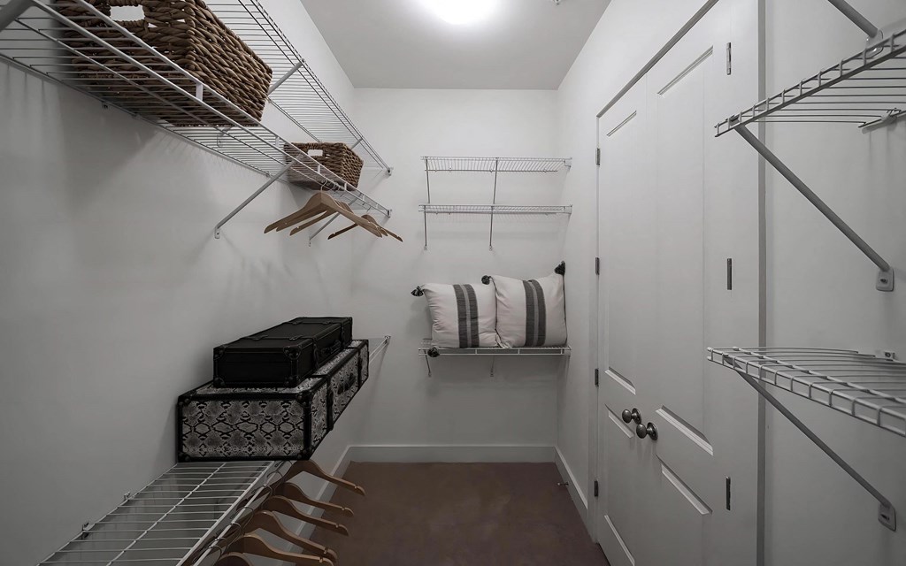 Spacious Walk-In Closet with Wire Shelving and Ample Hanging Space