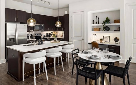 an open kitchen and dining area with a table and chairs