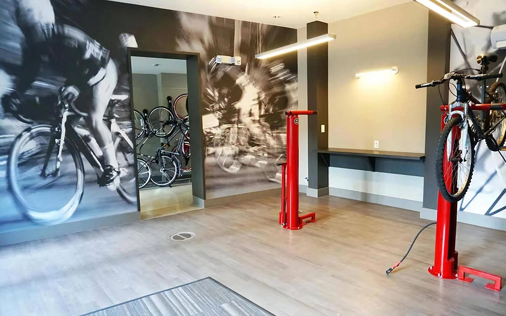 Indoor Bike Storage Room Featuring Repair Stands and Workstation