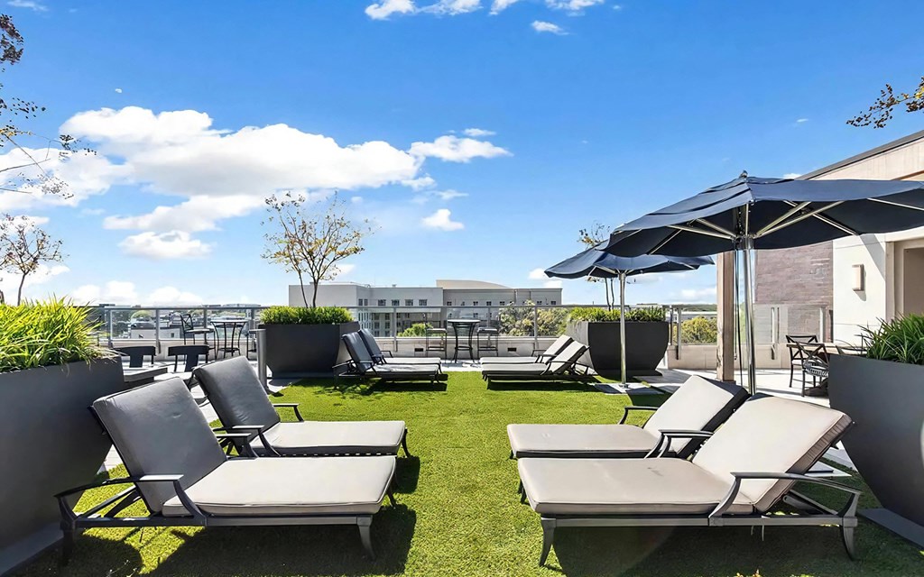 Rooftop Sky Deck With Lounge Chairs, Tables, and Shade Umbrellas