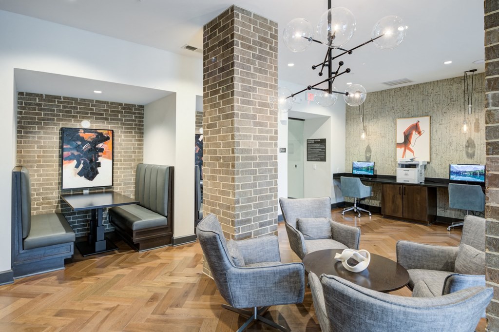a living room with a brick column and a table with chairs