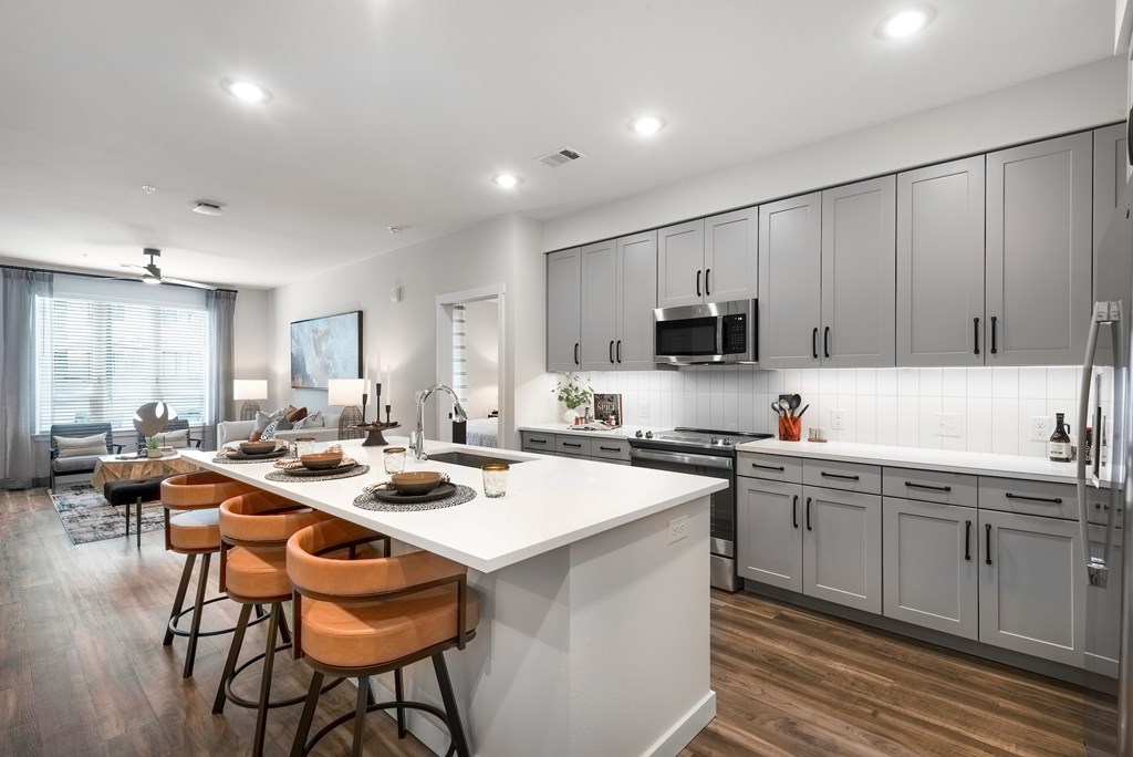 Open Concept Kitchen with Large Island, Grey Cabinets, and Bar Seating