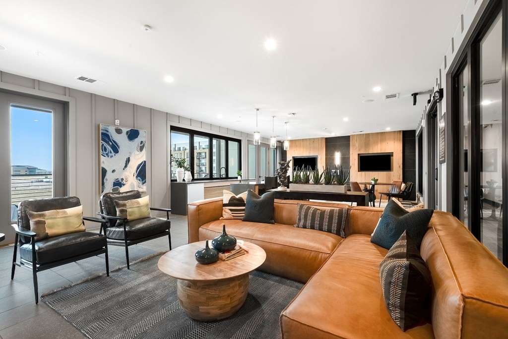 Stylish Resident Lounge with Cozy Sectional, Accent Chairs, and Wall-Mounted TVs
