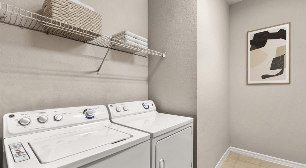 A white washing machine and dryer in a laundry room.
