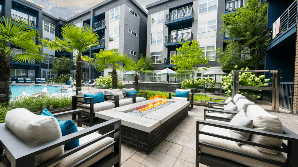 A patio with a table and chairs surrounded by buildings.