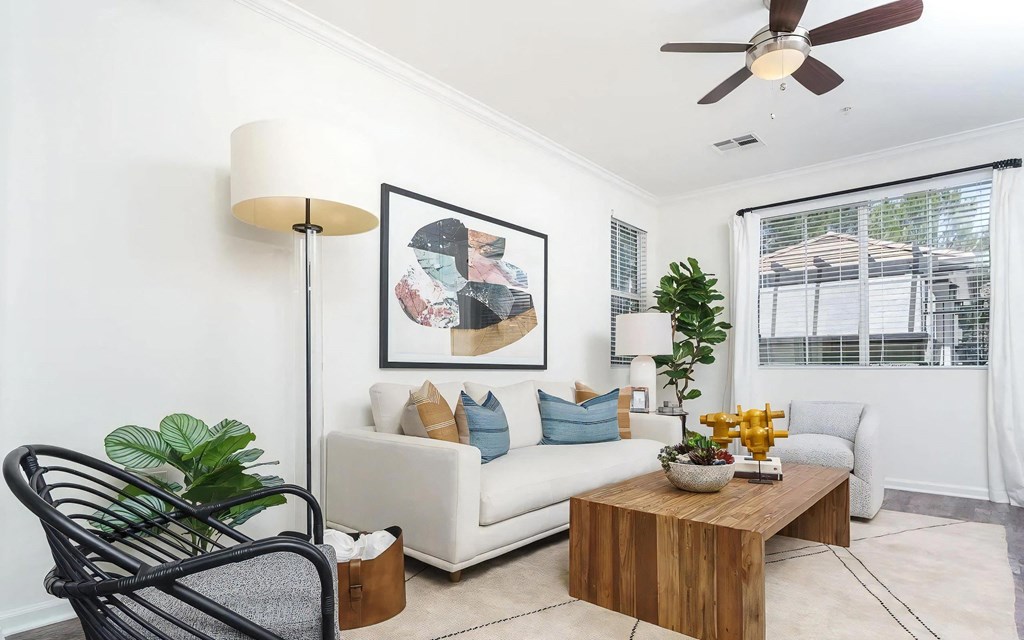 Living Room with Ceiling Fan and Multiple Windows