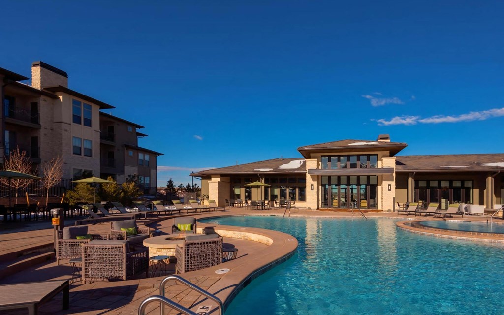 Resort Style Pool with Fire Tables and Lounge Chairs