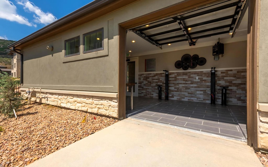 On-Site Bicycle Repair Shop With Open Garage Door Access
