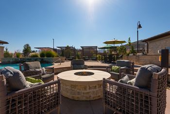 A sunny day at the outdoor seating area with a fire pit in the center.