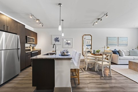 A modern kitchen with a dining area and a couch.