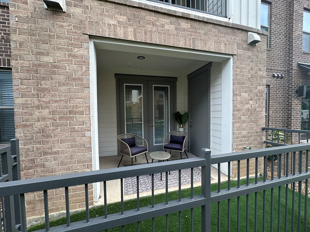 Ground-Level Patio with French Doors and Two Lounge Chairs