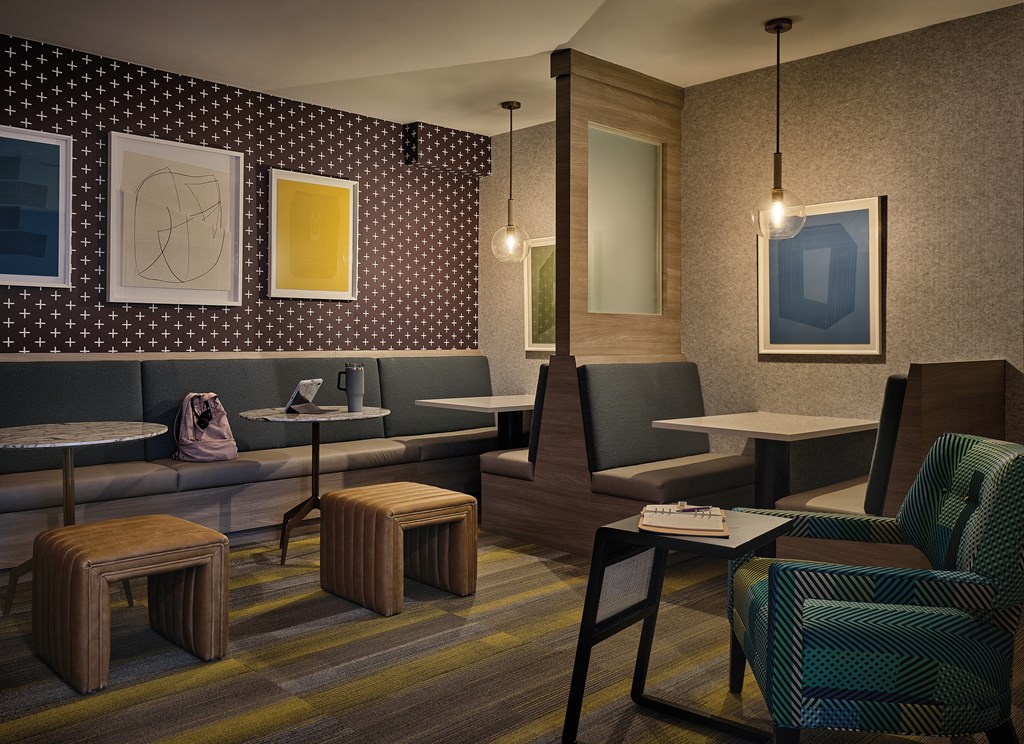 Resident Lounge Featuring Private Workstations, Soft Seating, and Accent Walls