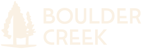 A logo with a tree and the words "BOULDER CREEK" in a light tan color.
