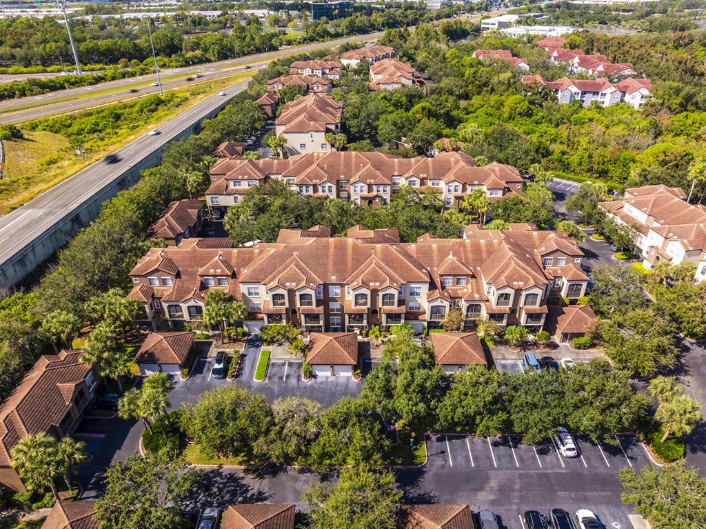 Aerial of residential buildings and parking area alongside highway access