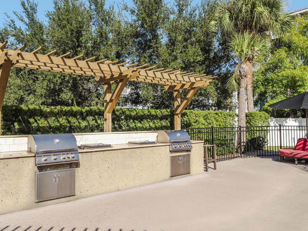 Community grill station with twin stainless grills under pergola
