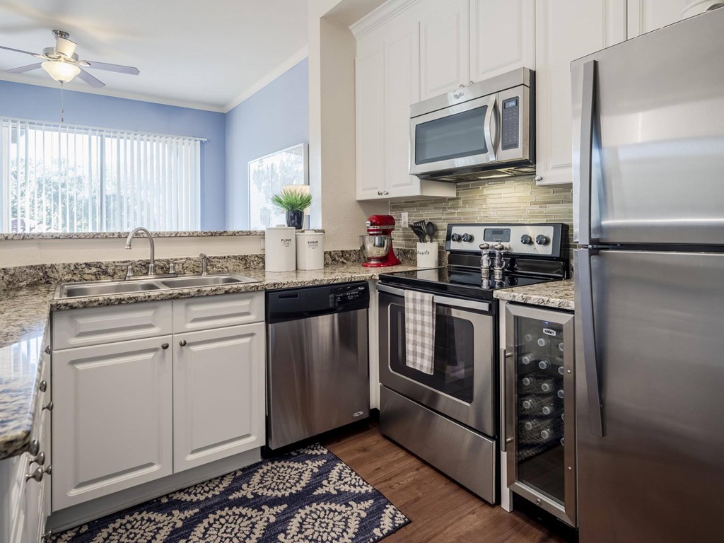 Kitchen with stainless appliances, granite counters and window light
