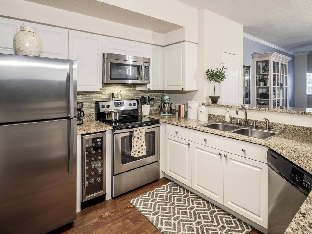 Modern kitchen with stainless appliances and granite counters