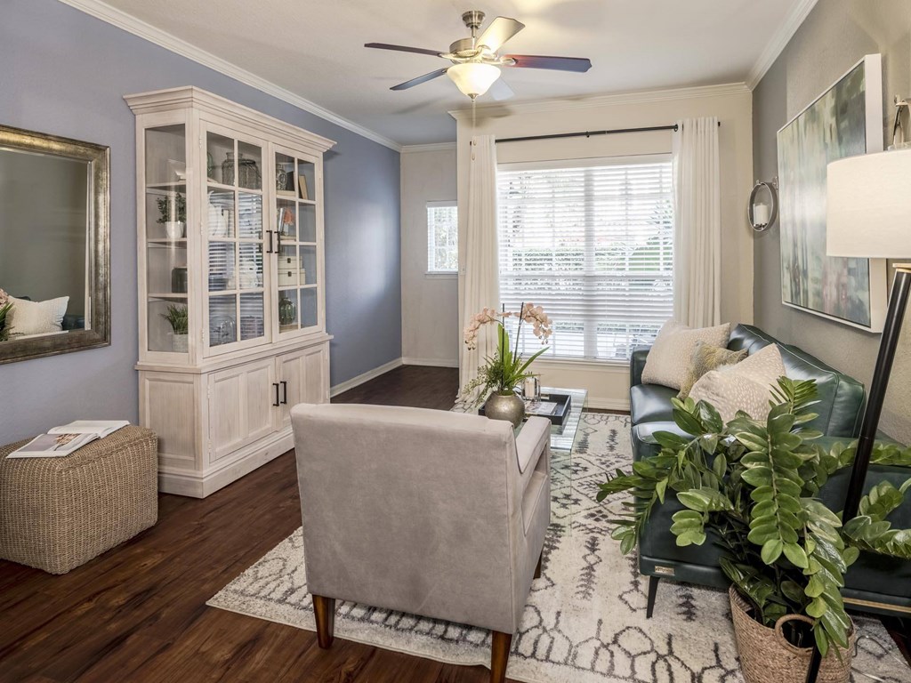 Cozy living room with hutch, armchair, and window light