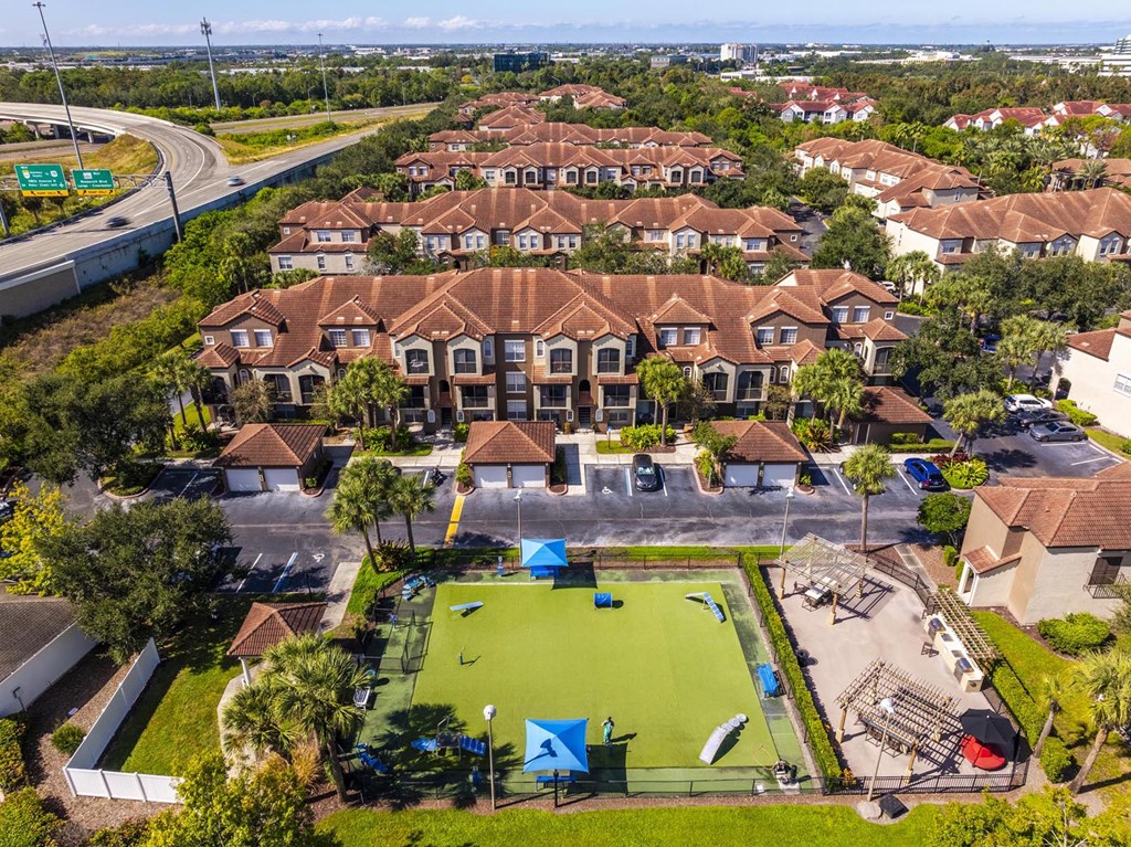 Elevated view of dog park surrounded by apartments and green space