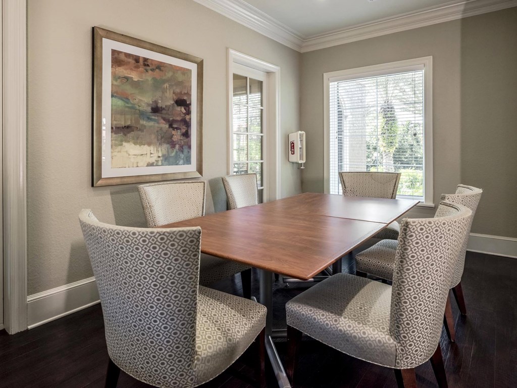 Private meeting room with a large table, comfortable chairs, and soft neutral décor.