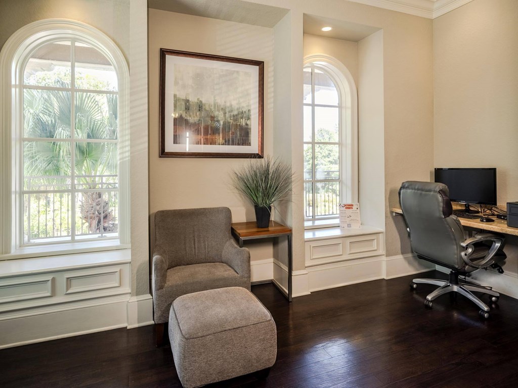 Resident business center featuring computer workstations, lounge seating, and natural light.