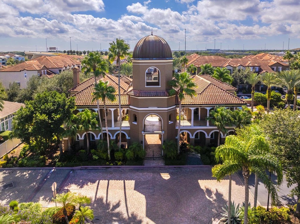 Iconic domed clubhouse surrounded by palm trees and Mediterranean architecture