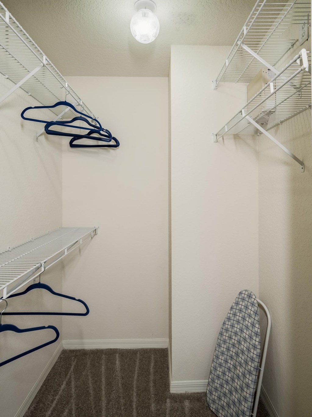 Walk-in closet with shelving and hangers
