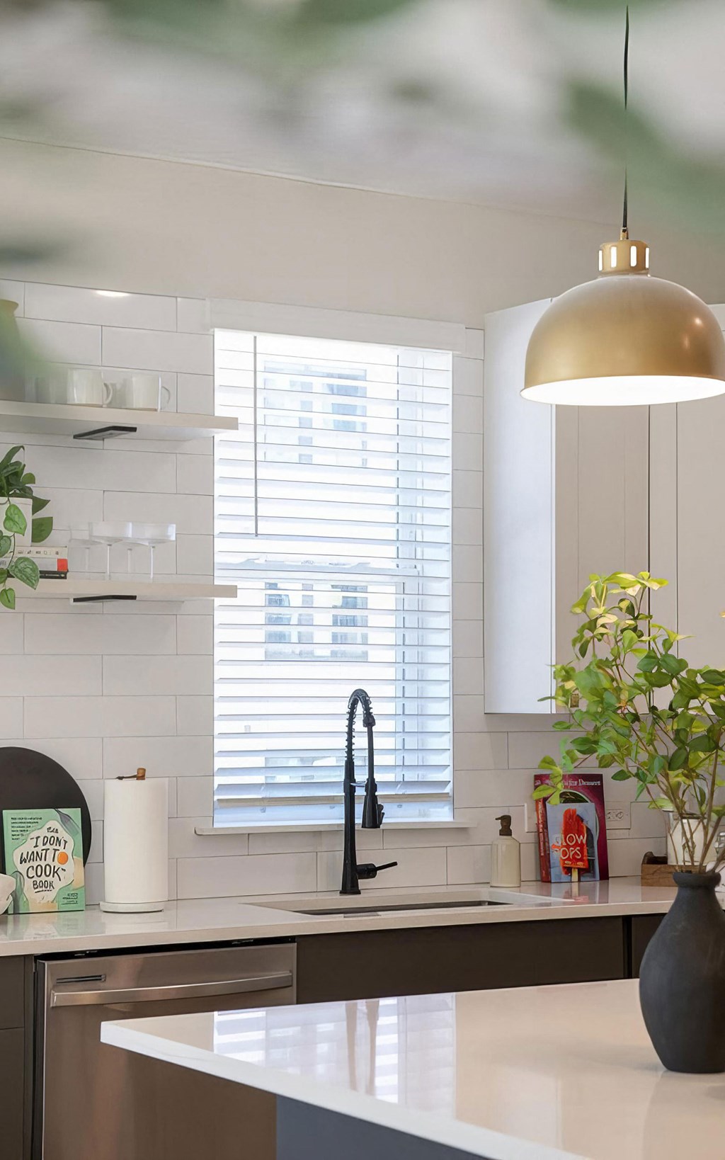 Clean kitchen with stainless steel appliances and modern shelving at Novel Cary