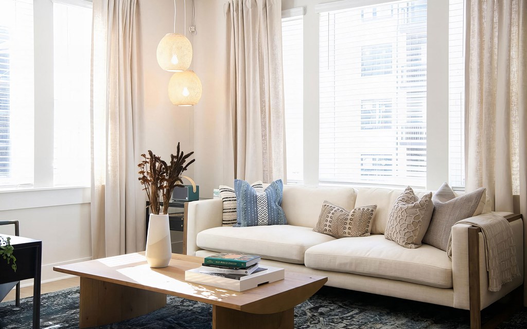 Cozy living room with giant windows and modern finishes at Novel Cary