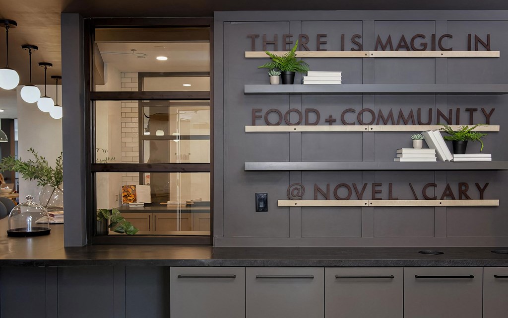 Modern coffeehouse-style social area with seating and full kitchen at Novel Cary