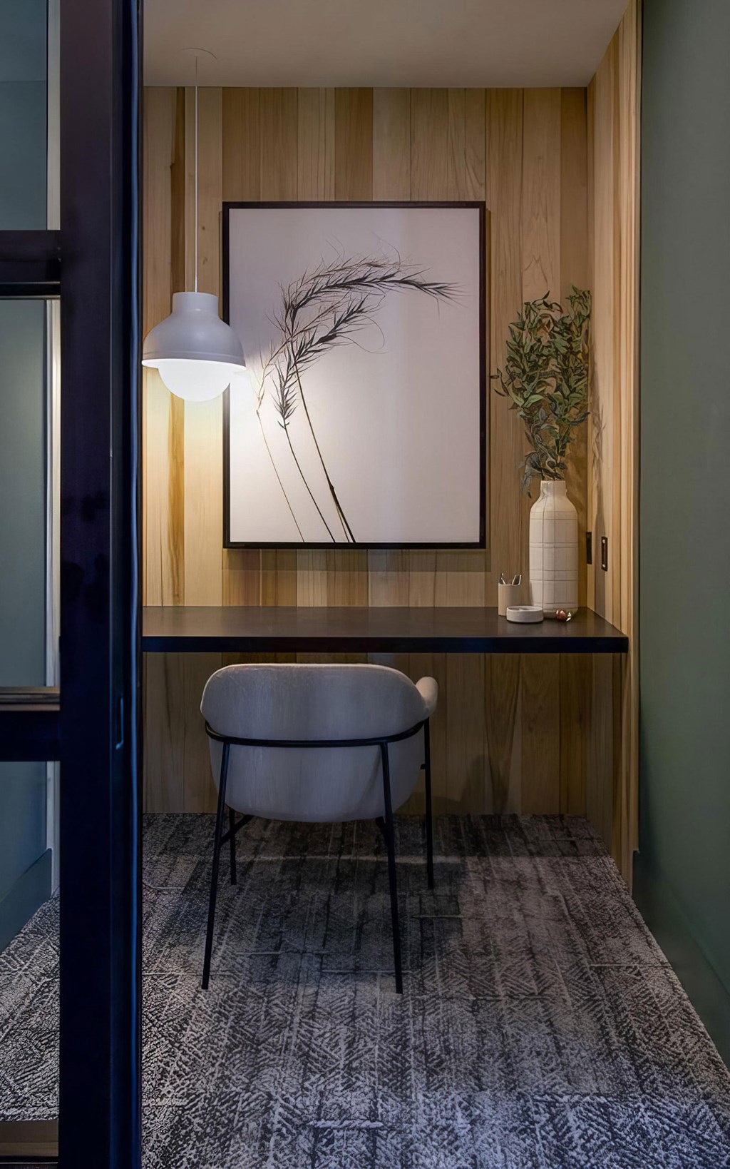 Private office area with desk and comfortable seating at Novel Cary