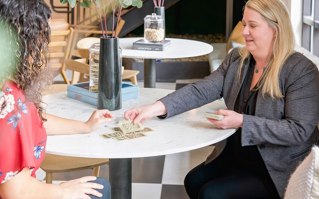 Social space with a variety of tabletop games and cards at Novel Cary