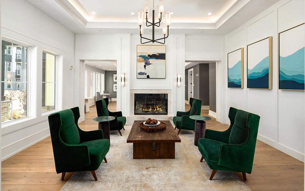 Stylish Lounge with Fireplace, Chandelier, and Velvet Accent Chairs