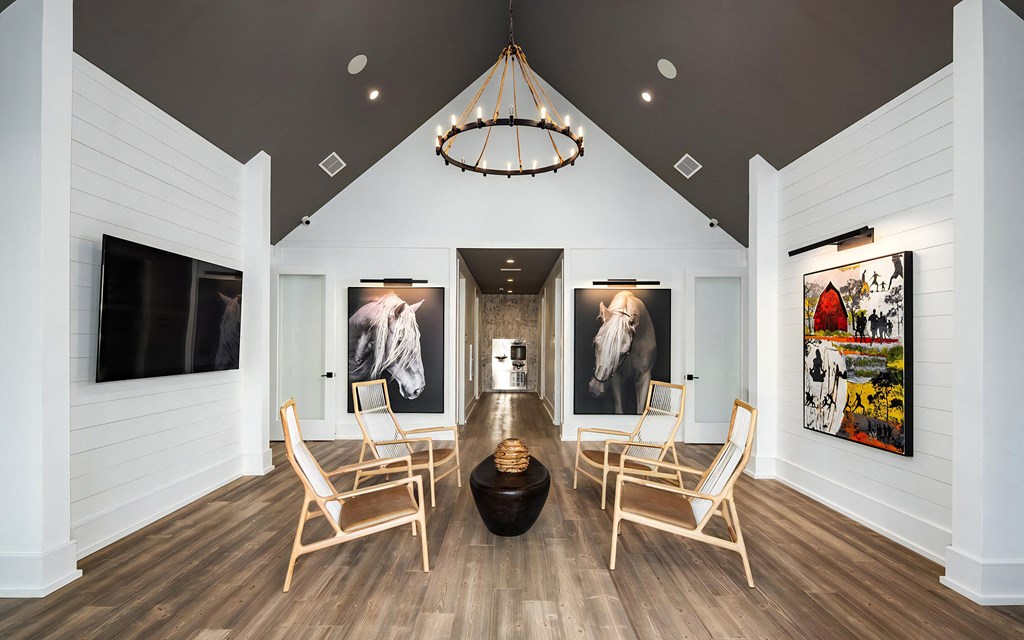 Bright Atrium Lounge with Vaulted Ceiling, Artistic Decor, and Wood Accents