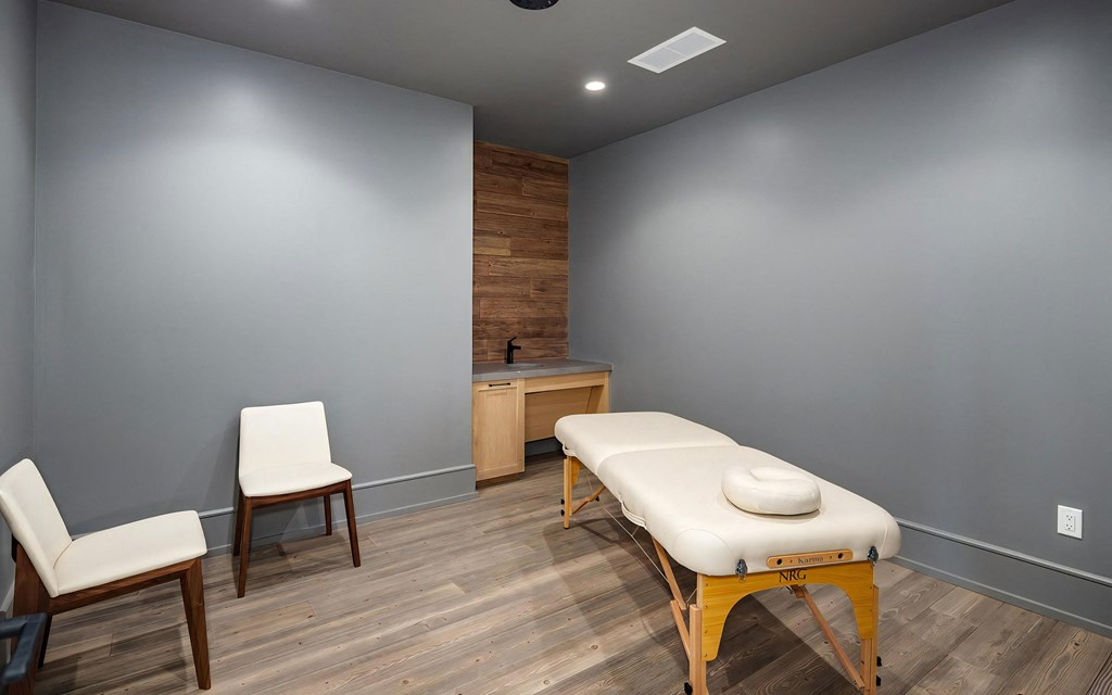 Serene Massage Space Featuring Wood-Trim Sink Area and Soft Lighting
