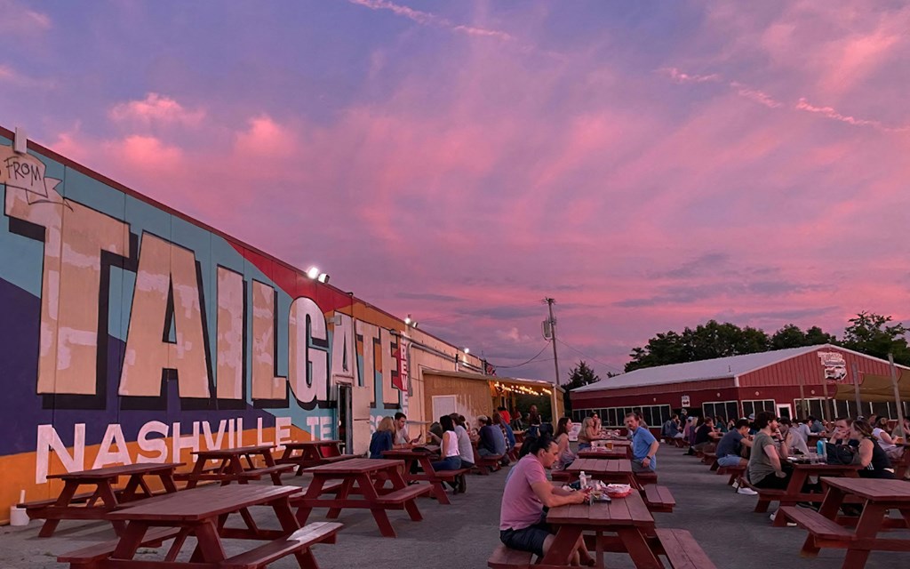 Evening at TailGate Brewery Featuring Wall Mural and Open-Air Seating